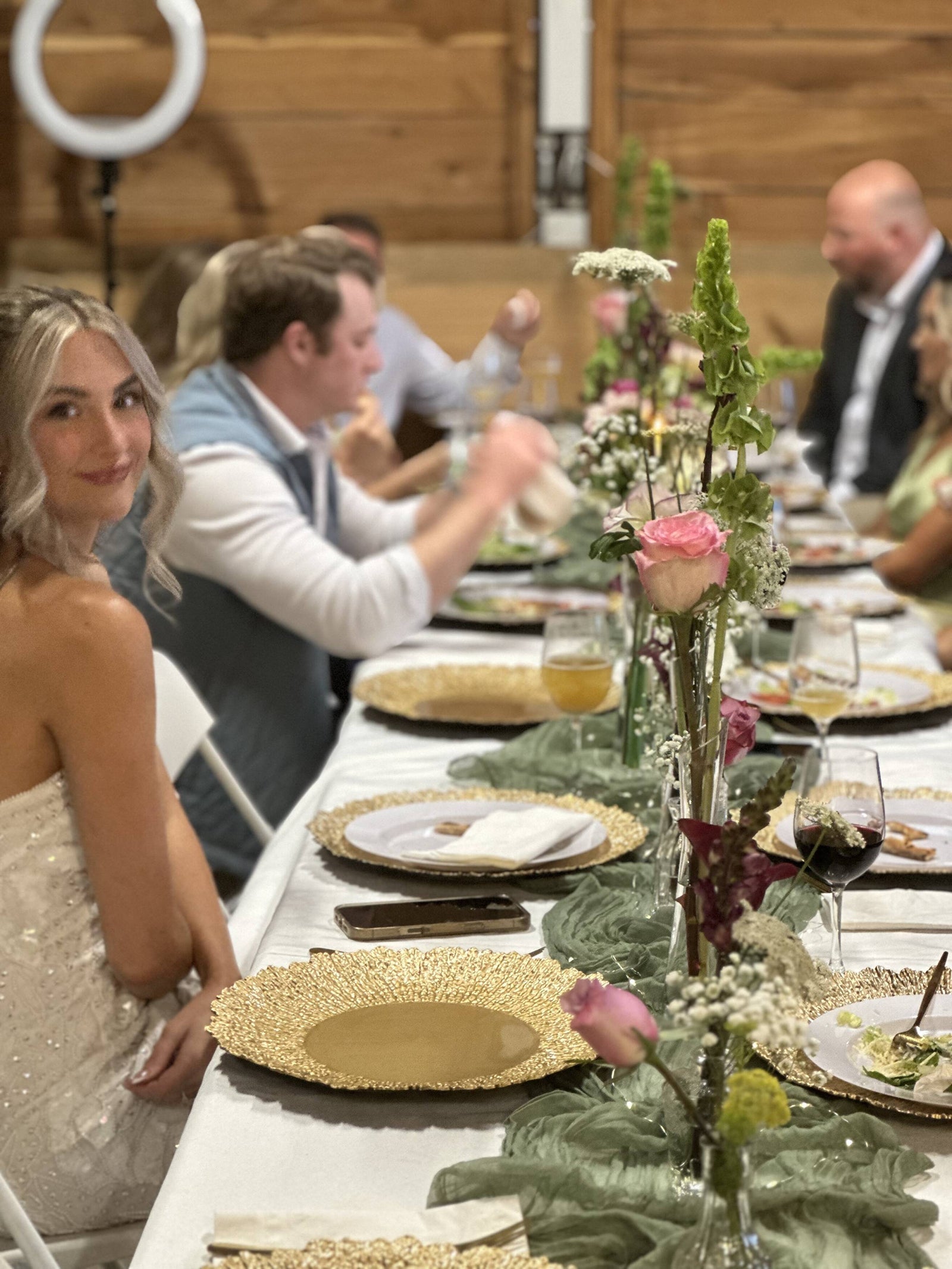 Guests sharing a flower-decorated reception table at VineCrafters