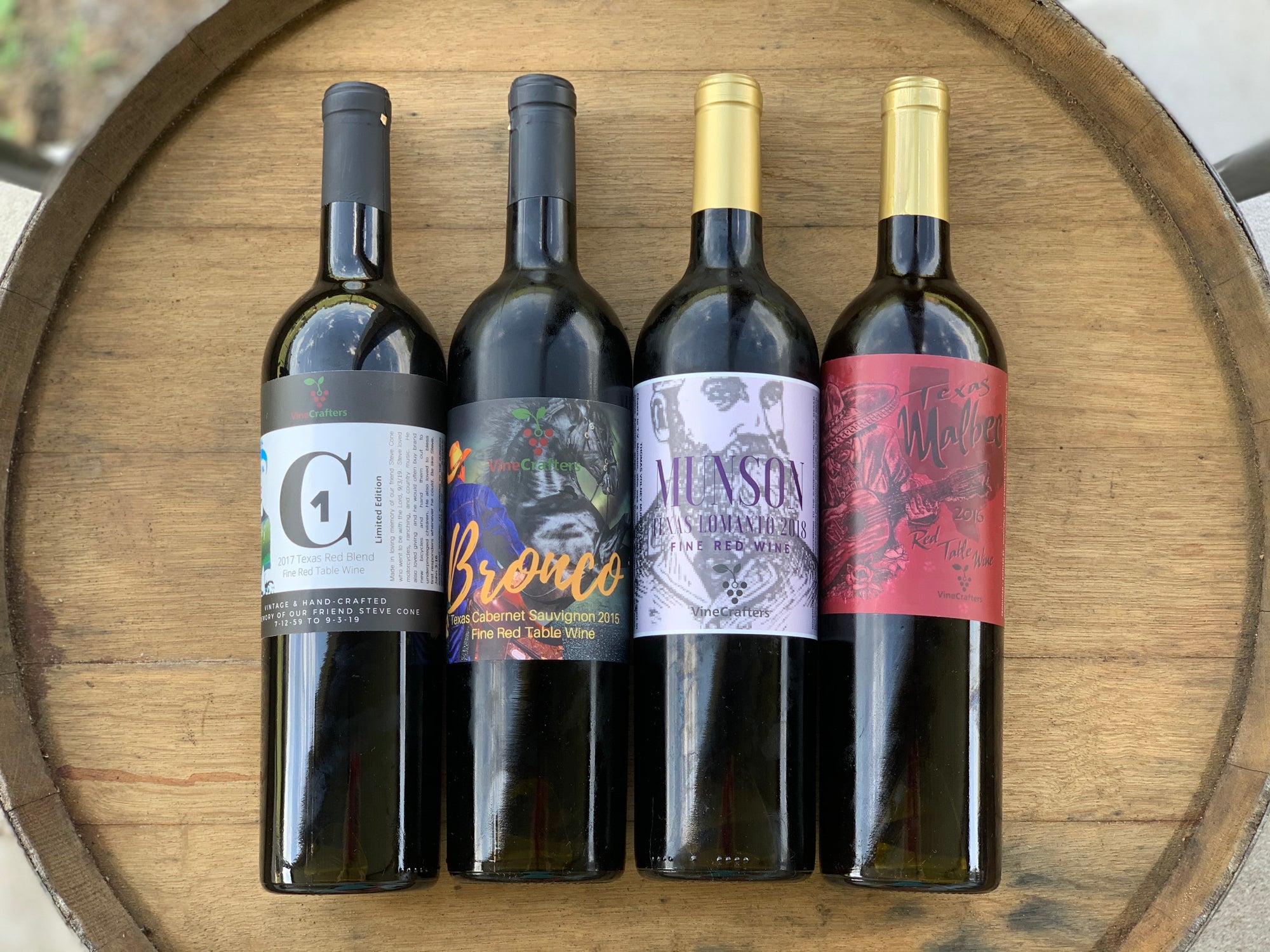 VineCrafters Texas wines arranged on a wooden barrel